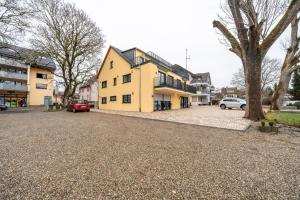 a yellow house on the side of a street at City Villa Bad Dürrheim - Penthouse in Bad Dürrheim