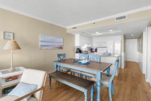 a kitchen and dining room with a table and chairs at 5th Flr Oceanfront 2 Bedroom Condo in Pawleys Island