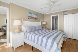 a bedroom with a bed and a ceiling fan at 5th Flr Oceanfront 2 Bedroom Condo in Pawleys Island +11 photos