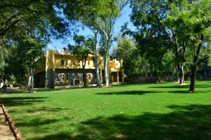 a building in the middle of a park with trees at Ranthambhore Tiger Territory in Sawāi Mādhopur +6 photos