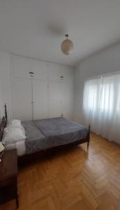 a bedroom with a bed and a wooden floor at Departamento bolivar in Mar del Plata