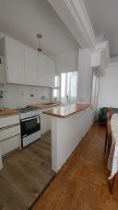 a kitchen with white cabinets and a counter top at Departamento bolivar in Mar del Plata