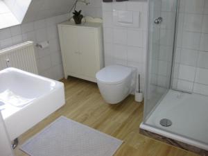 a bathroom with a toilet and a sink and a shower at Strandlust in Prerow