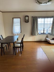 a living room with a dining room table and chairs at 暮らし家 Nagasima Nagoya in Yatomi 