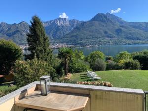 a balcony with a view of a lake and mountains at Villa Oliveto apartments in Oliveto Lario