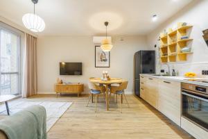 a kitchen with a table and a dining room at Butique Apartament - Old Town in Rzeszów