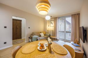 a living room with a table and a couch at Butique Apartament - Old Town in Rzeszów