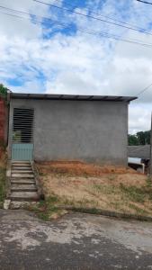a building with a door and stairs in front of it at Qroom Janaina in Cruzeiro do Sul