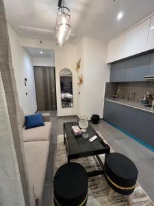 a living room with a couch and a table at Sukoon by Urban Retreat in New Delhi