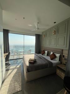 a bedroom with a bed with a view of the ocean at Sukoon by Urban Retreat in New Delhi