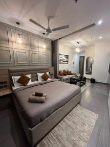 a bedroom with a large bed and a living room at Sukoon by Urban Retreat in New Delhi