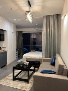 a living room with a couch and a bed at Sukoon by Urban Retreat in New Delhi +14 photos