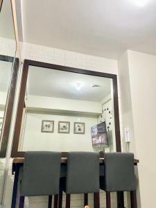 a dining room with a mirror and a table and chairs at The Luna's at Wind Residences in Kaybagal +4 photos