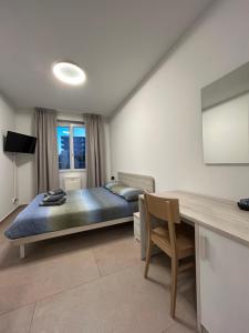 A television and/or entertainment centre at *Veranda's rooms* - Free parking in central Lugano