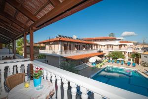 a balcony with a swimming pool and a building at Anadiomeni Pool & Beach Apartments by "elite" in Zakynthos