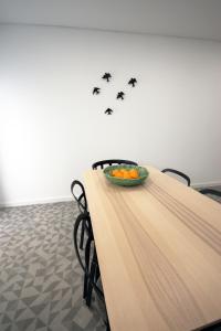 a table with a bowl of fruit and black birds at 19inLisbon in Lisbon