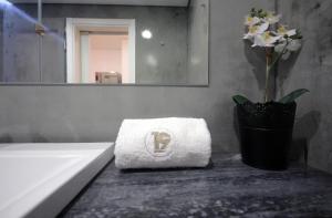 a bathroom with a sink and a towel on a counter at 19inLisbon in Lisbon
