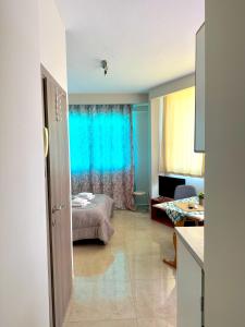 a room with a bed and a blue curtain at Alpha apartments 35 in Serres