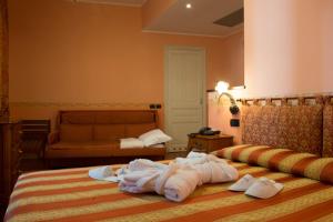 Postel nebo postele na pokoji v ubytování Hotel Belle Epoque