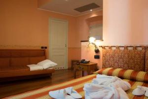 Postel nebo postele na pokoji v ubytování Hotel Belle Epoque