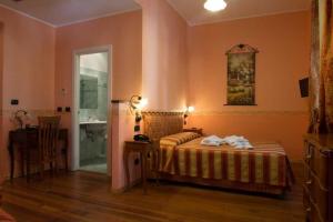 Postel nebo postele na pokoji v ubytování Hotel Belle Epoque