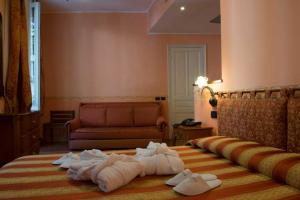 Postel nebo postele na pokoji v ubytování Hotel Belle Epoque