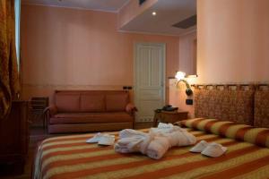 Postel nebo postele na pokoji v ubytování Hotel Belle Epoque