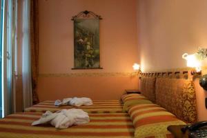 Postel nebo postele na pokoji v ubytování Hotel Belle Epoque