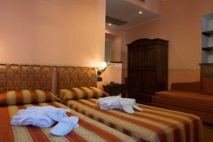 Postel nebo postele na pokoji v ubytování Hotel Belle Epoque