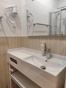 a bathroom with a white sink and a mirror at Bacalhoeiros 125 Hotel in Lisbon +39 photos