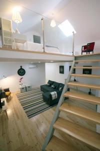 a living room with a loft bed and a staircase at 19inLisbon in Lisbon
