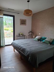 a bedroom with a large bed and a large window at Villa MOUREZEVA in Mourèze +39 photos