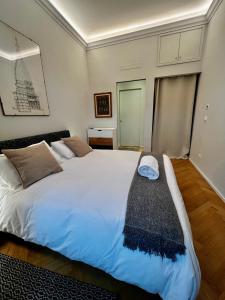 a bedroom with a large white bed with a black blanket at Suite Florio in Turin