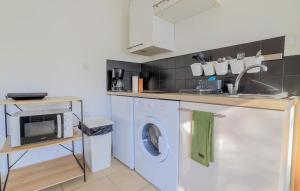 a kitchen with a washing machine and a sink at 1 Bedroom Gorgeous Home In Saint-Josse in Saint-Josse
