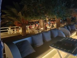 a row of chairs and tables on a patio at night at Zephyros in Paraga