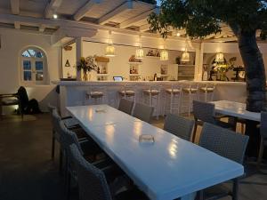 a restaurant with tables and chairs and a bar at Zephyros in Paraga
