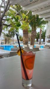a drink sitting on a table next to a pool at Zephyros in Paraga