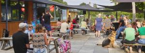 a crowd of people sitting outside of a building at Huis Meerwijck in Gasselte +16 photos