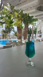 a glass of blue liquid sitting on a table at Zephyros in Paraga