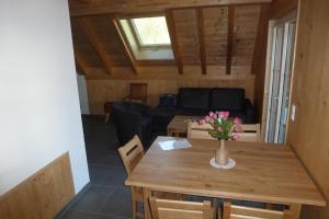 a dining room and living room in a tiny house at Rommelehof in Gutach