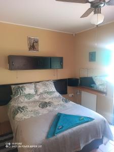 a bedroom with a bed with a blue towel on it at In Between Home in Lydenburg