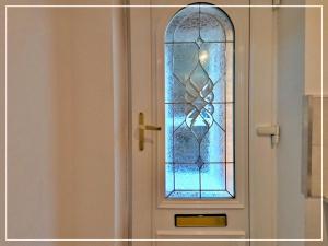 a door with a stained glass window on it at Modern Studio Appartment in Cheltenham
