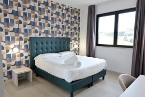 Postel nebo postele na pokoji v ubytování Hotel HE ROMA