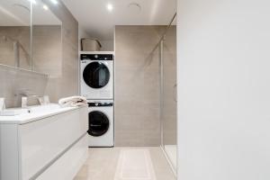 a bathroom with a washer and dryer and a sink at Cosy and Premium Stay Mons in Mons +37 photos