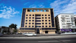 a building on a street with cars in front of it at Mirada Blue Falestine - Serviced Apartments in Jeddah