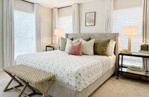 a bedroom with a large white bed with pillows at Charming Cottage for Family and Dogs near Beach & City in Savannah