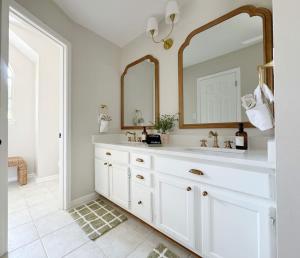 a white bathroom with a sink and a mirror at Charming Cottage for Family and Dogs near Beach & City in Savannah
