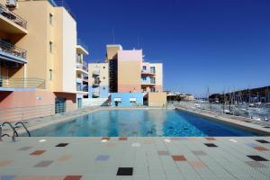 an empty swimming pool in front of some buildings at A Concha in Albufeira