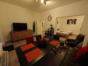 a living room with a table and a television at Ursula 2 in Oedt