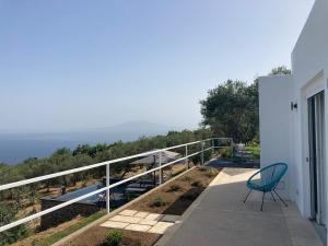 a green chair sitting on a balcony of a house at “CapriOleum” esclusive place in Anacapri